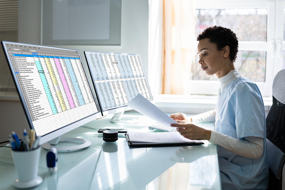 Office administrator infront of computer screens